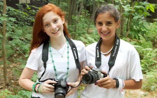 a couple of women holding a camera