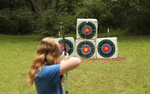 a girl shooting target archery