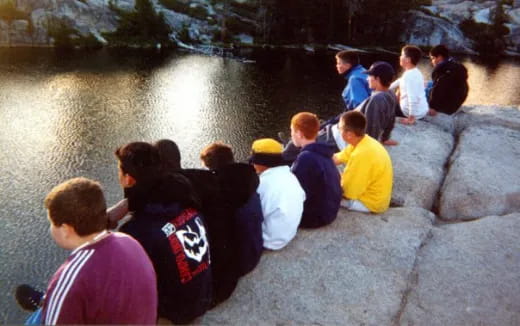 a group of people sitting on rocks