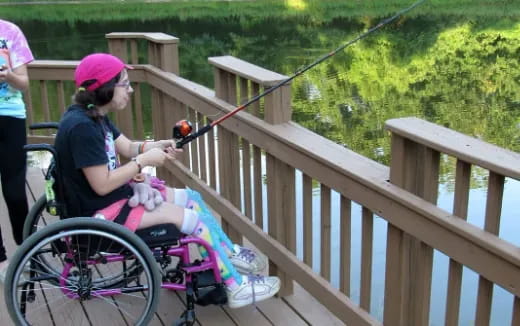 a woman in a wheelchair on a bridge
