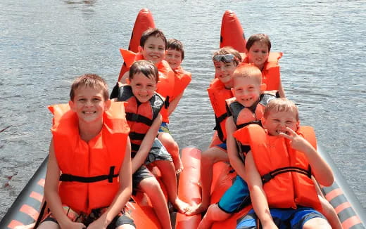 a group of people in life jackets on a raft
