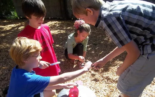 a group of people playing with sand
