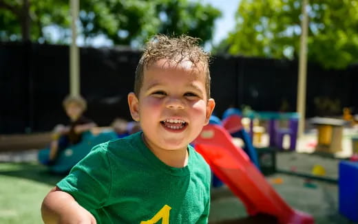 a boy smiling at the camera
