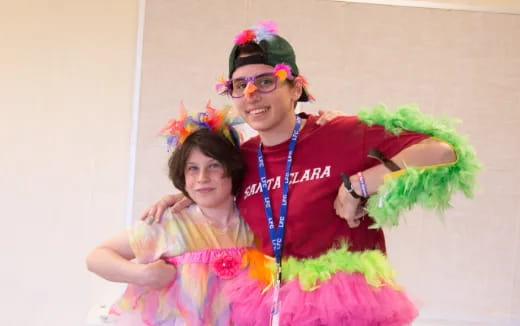 a person and a girl wearing colorful clothing