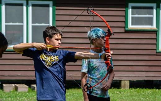 a man and a woman playing with a bow and arrow