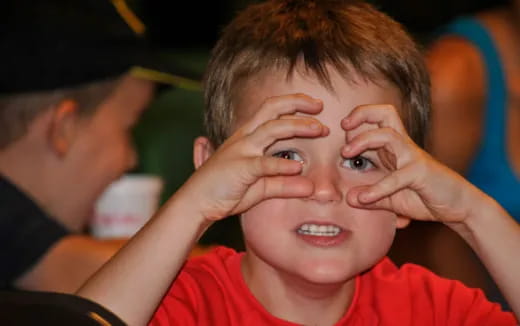 a boy with his hands on his face