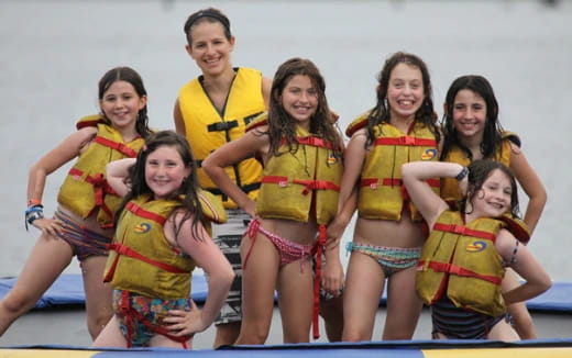 a group of women in swimsuits posing for a photo