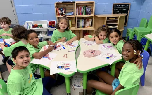 a group of children sitting at desks in a classroom