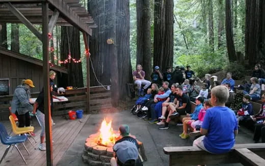 a group of people sitting around a fire