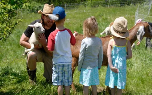 a group of children holding animals