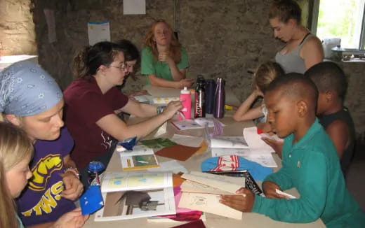 a group of children sitting around a table