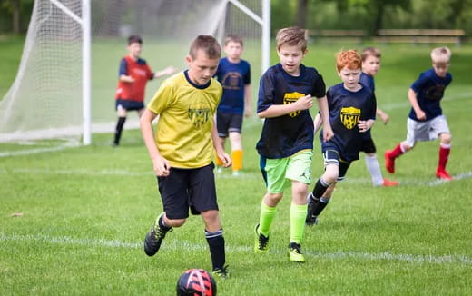 a group of kids playing football