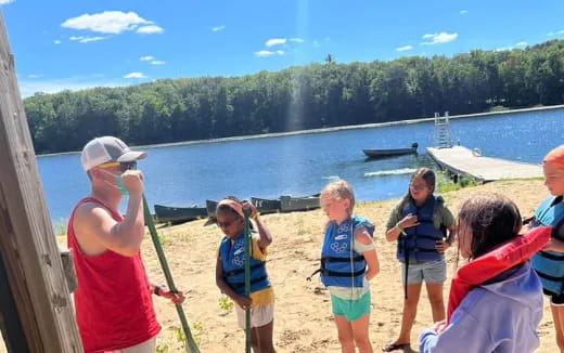 a group of people standing on a beach