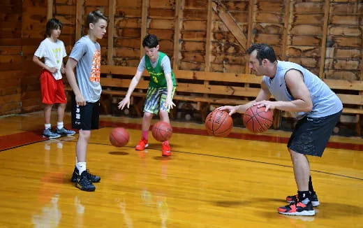 a group of kids playing basketball