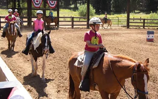 a group of people riding horses