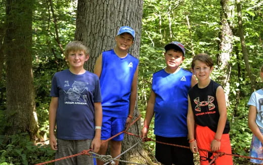 a group of people standing by a tree