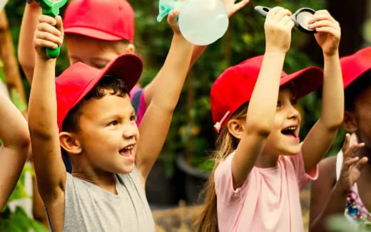 a group of children holding up their hands