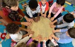 a group of children playing with a large turtle