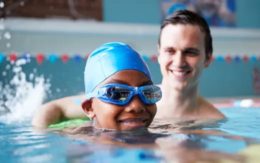 a boy and girl in a pool