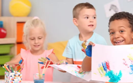 a group of children sitting at a table