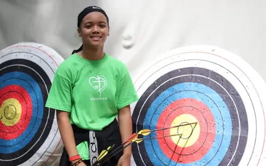 a person standing next to a large colorful wheel