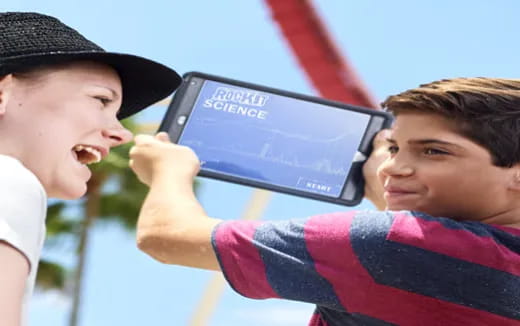 a boy and a girl looking at a tablet