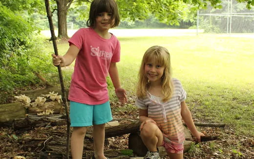 a couple of children on a swing