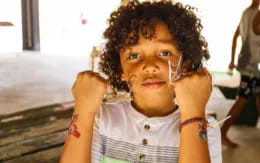 a young boy with curly hair