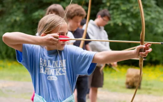 a group of kids playing with sticks