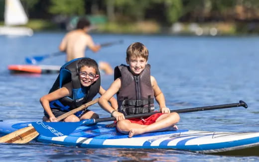 a couple of kids in a canoe