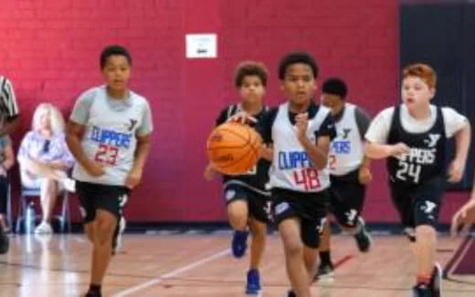 a group of people playing basketball