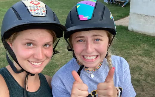 a man and woman wearing helmets