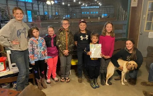 a group of people posing for a photo with a dog