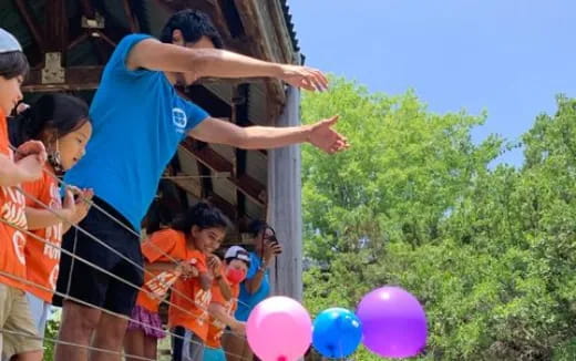 a group of children holding balloons