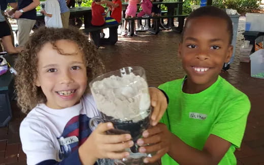 a couple of children holding a trophy