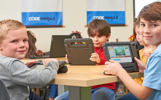 a group of kids using laptops