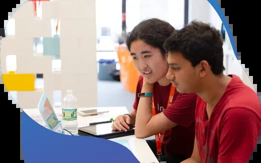 a few young men looking at a computer
