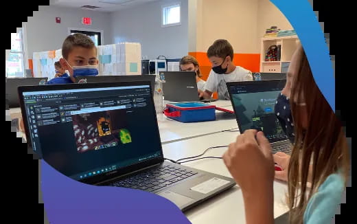 a group of people using laptops