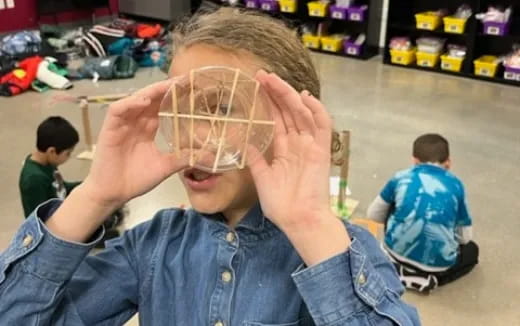 a boy holding a plastic bag over his face