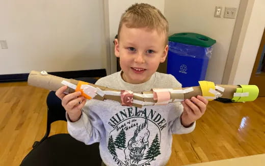 a boy holding a toy gun