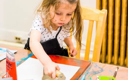 a young girl coloring on a paper