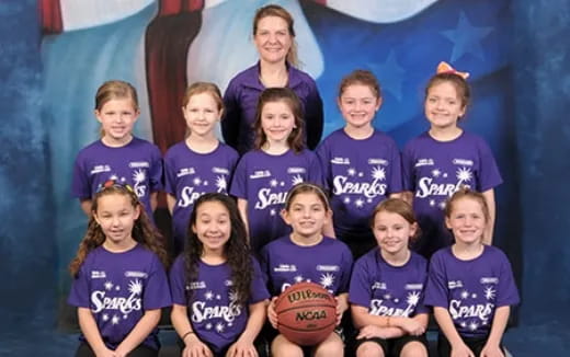 a group of girls wearing purple shirts