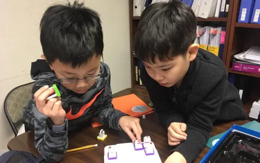 a couple of boys playing with a toy