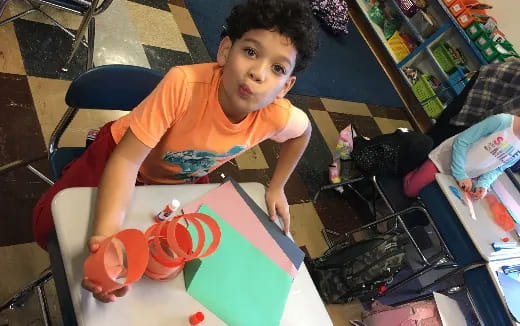 a boy sitting at a table