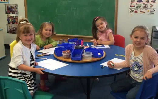a group of children sitting at a table