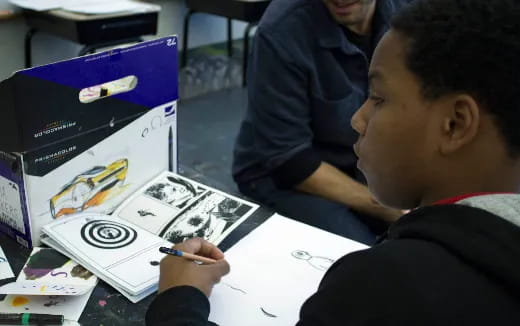 a man drawing on a table