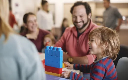 a person and a child playing with a toy