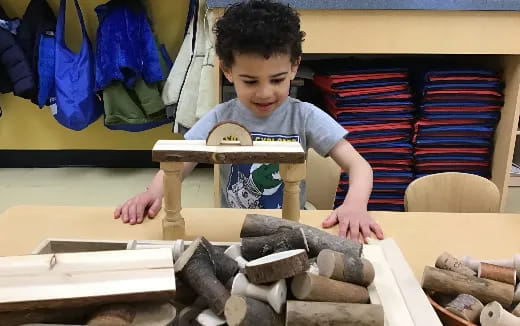 a boy playing with wooden blocks