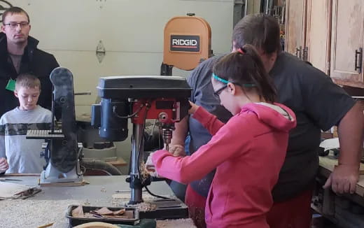 a group of people working on a machine