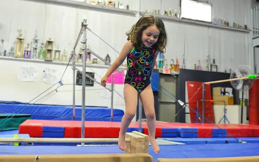 a girl in a swimsuit on a trampoline